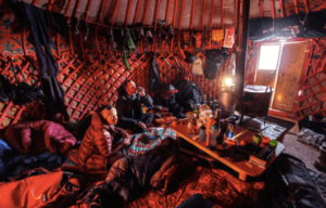inside of a yurt with people that are skiing in kyrgyzstan