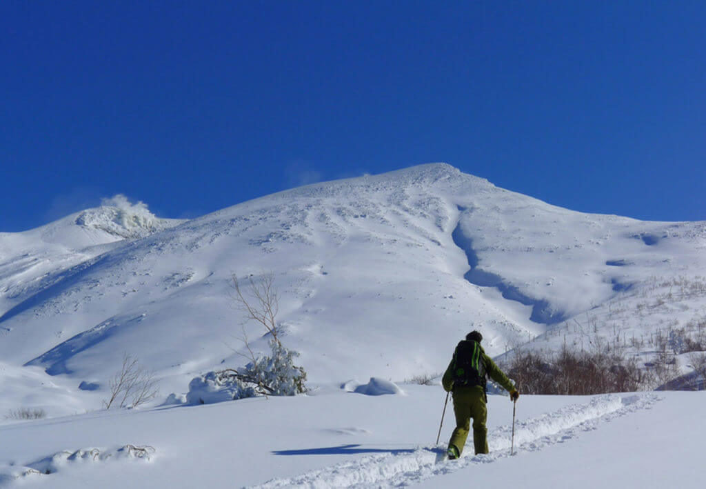 hiking to tokachidake mountain for powder skiing in Japan